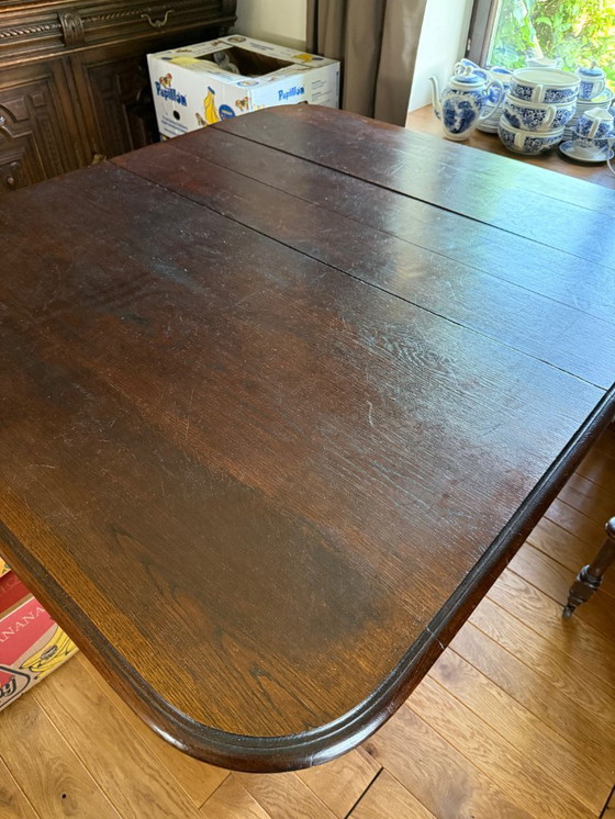 Image 1 of Antique, oak extendable table and 8 matching chairs on casters