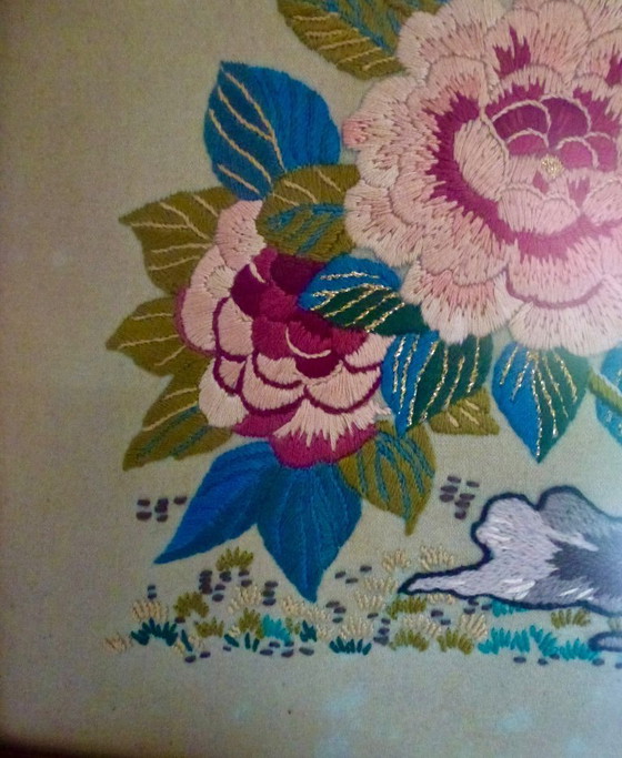 Image 1 of Vintage hand-embroidered wall tapestry, behind glass, with a crane, butterflies and flowers.