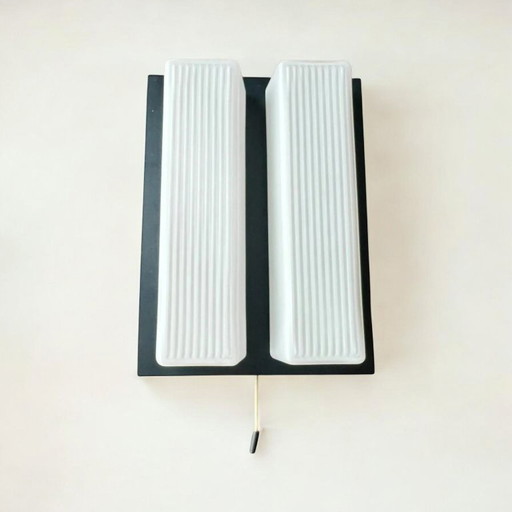 2 Mid - Century wall lamps with pull switch or for direct mounting. Frosted glass on metal body with flat silhouette, 60s