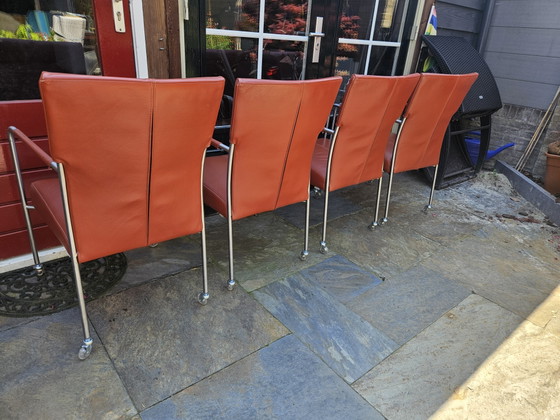 Image 1 of 4 red leather dining chairs on wheels, brand Bert Plantagie