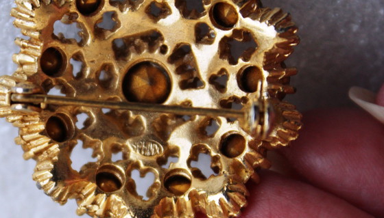 Image 1 of Vintage costume jewelry brooch with amber rhinestones, marked SPHINX