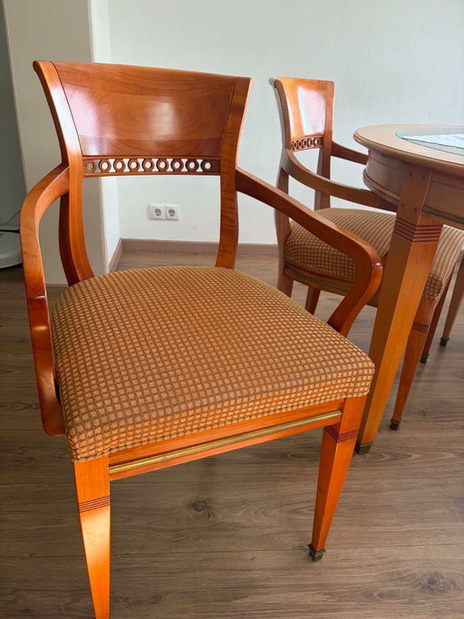 round wooden dining table with glass top and 4 matching chairs