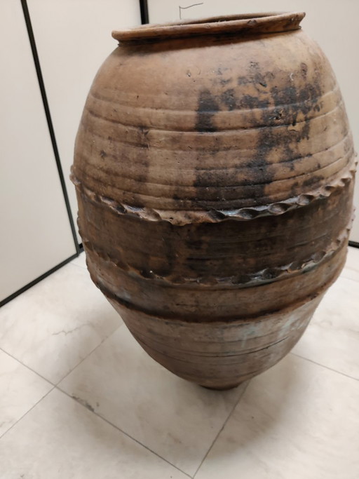 Large antique terracotta pot with a red tint