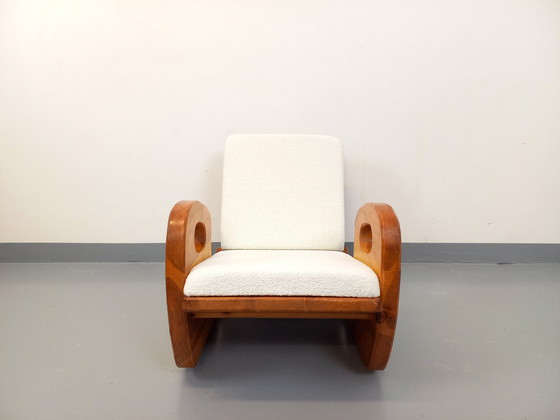 Image 1 of 50's Brutalistische Jean Touret schommelstoel in massief grenen en Bouclette stof