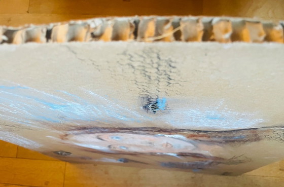 Image 1 of A female portrait painting created on old, worn, honeycomb-patterned cardboard packaging.