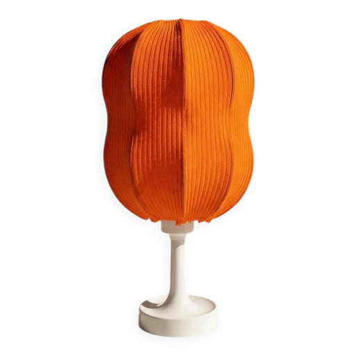 Lamp with a plastic base and a coloured fabric shade in Mid Century style.