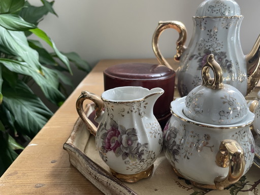 Vintage tea set with gold details and floral motif