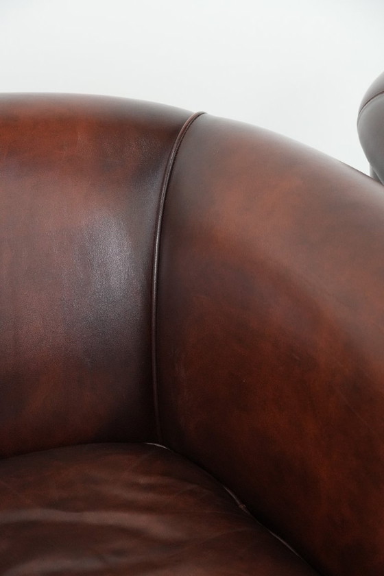 Image 1 of 2 poltrone club in pelle bovina in buone condizioni, di un lussuoso colore rosso/marrone.