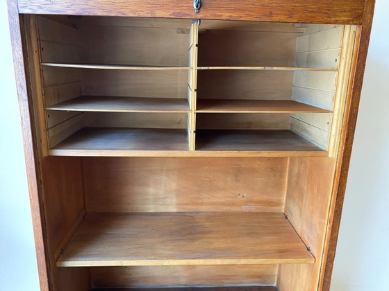 Image 1 of Antique German oak roll-top wardrobe with original key and working wooden roll-top. Made around 1920–1935