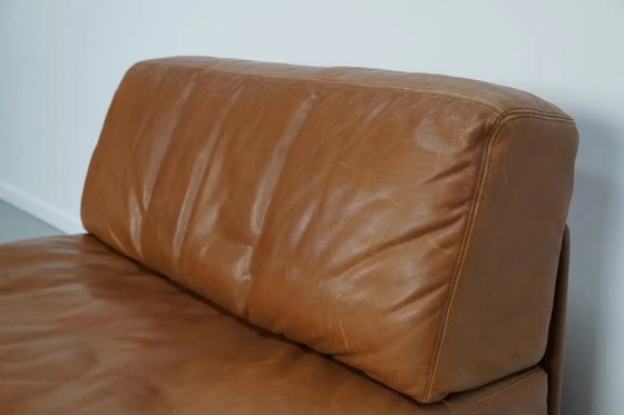Image 1 of De Sede DS 76 loungestoel / slaapbank van cognackleurig leer, Zwitserland, jaren 1970