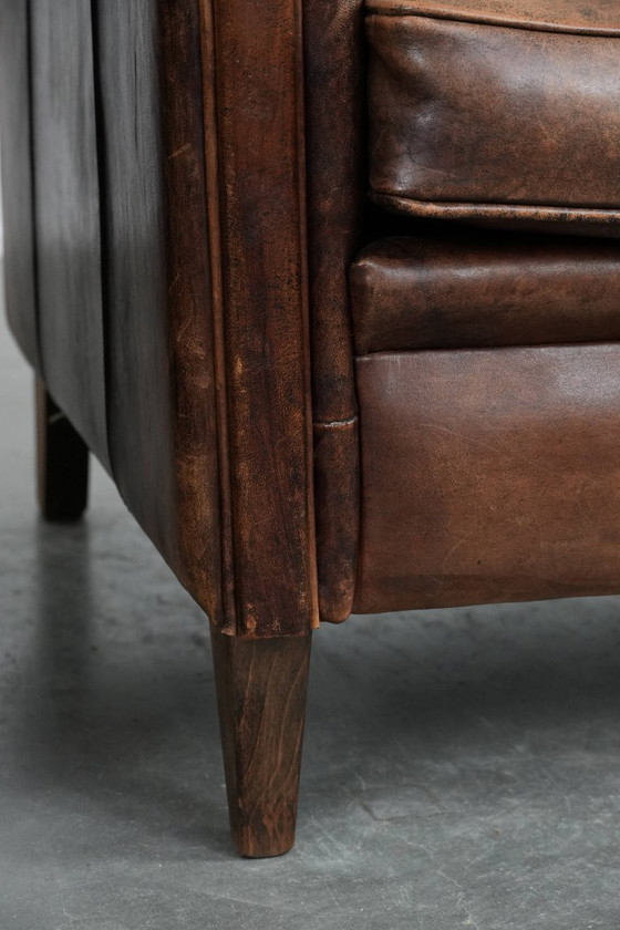 Image 1 of 2 x Vintage sheepskin armchair with warm colours and a characterful appearance