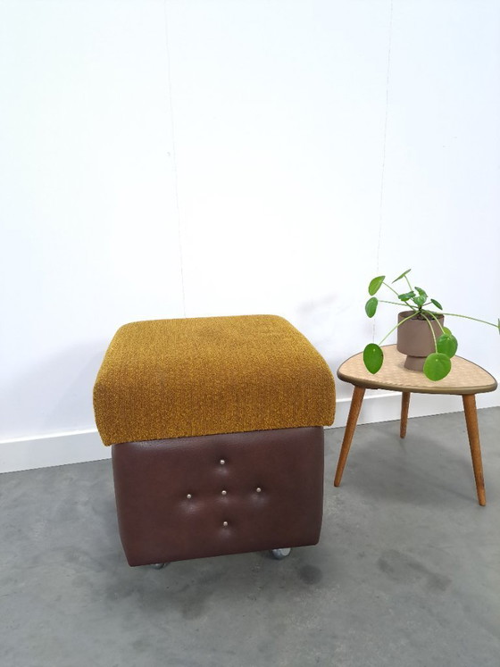 Image 1 of Ottoman with lid on chrome wheels