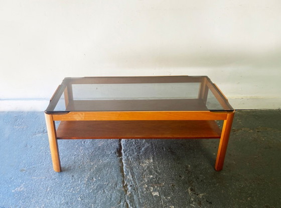 Image 1 of Table basse en teck style années 50 avec plateau en verre fumé, par Myer