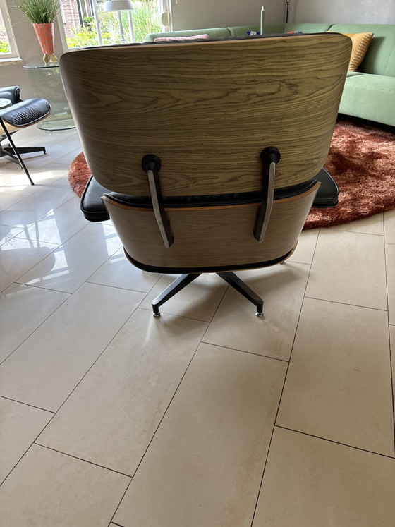 Image 1 of 2 x leather Eames armchairs with ottoman (replica)