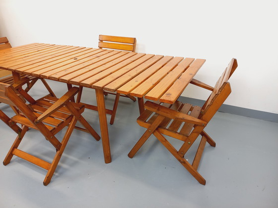 Image 1 of Vintage garden furniture consisting of a table with extensions and 4 wooden armchairs from the 60s