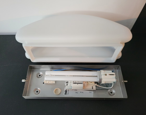 Image 1 of 3 RAAK (bathroom) wall lamps with opaline glass shade and stainless steel frame.