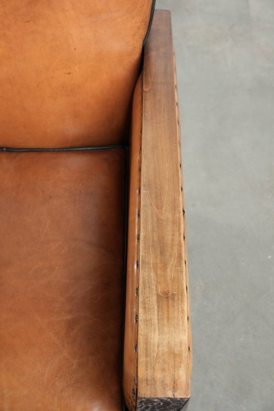 Image 1 of 2 x Prachtige schapenleren Art Deco fauteuil met mooi houtsnijwerk en zwarte biezen