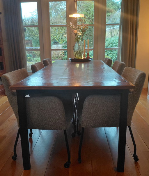Old teak dining table with steel base