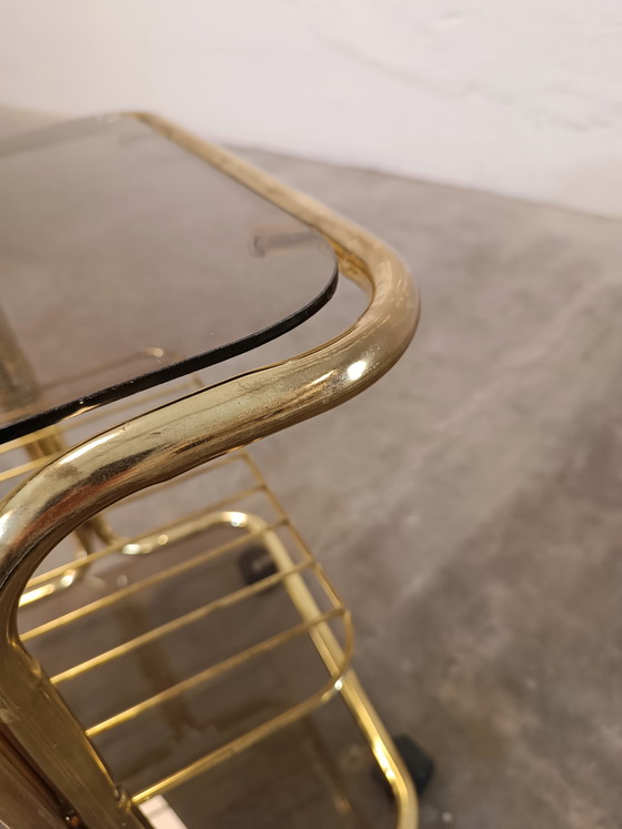 Image 1 of Vintage gold coloured and glass trolley side table 