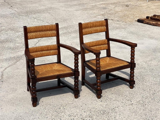 Pair of stained oak and straw armchairs, French work 1950