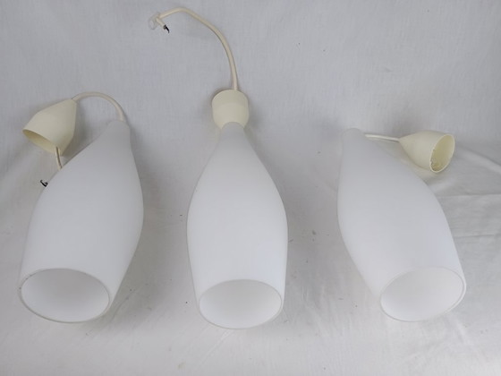 Image 1 of Elegant and timeless, this set of three original Holmegaard glass pendant lamps