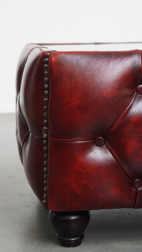 Image 1 of Beef leather chesterfield side/ coffee table in a red color with glass top