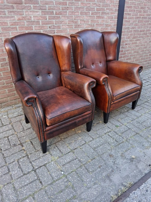 Twee oorfauteuils schapenleer – Wood