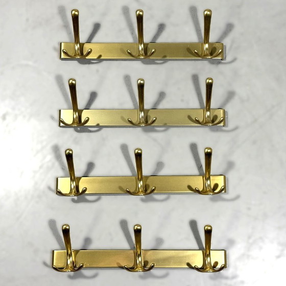 Image 1 of Goudkleurige aluminium wandkapstokken jaren 1960