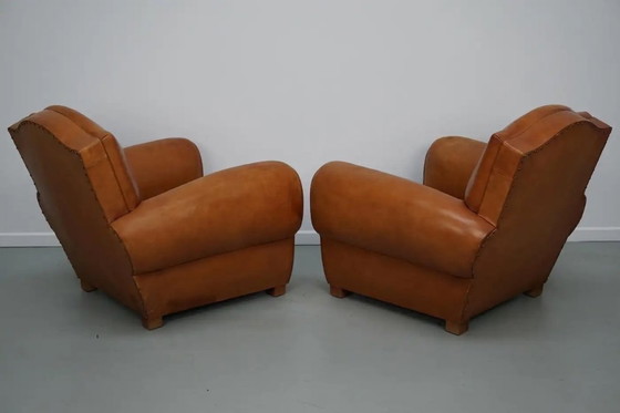 Image 1 of Ein Paar französischer cognacfarbener Ledersessel mit schnurrbartförmigen Rückenlehnen, 1950er Jahre