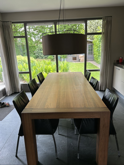Mooie notenhouten eettafel met 8 lederen stoelen van Nomada