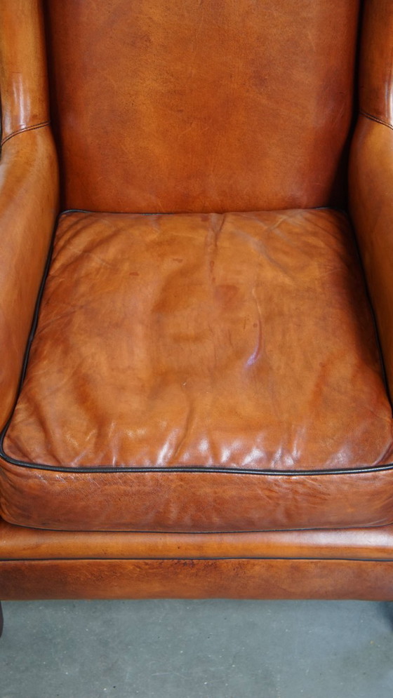 Image 1 of Schapenleren armchair met hoge rug en zwarte biezen 