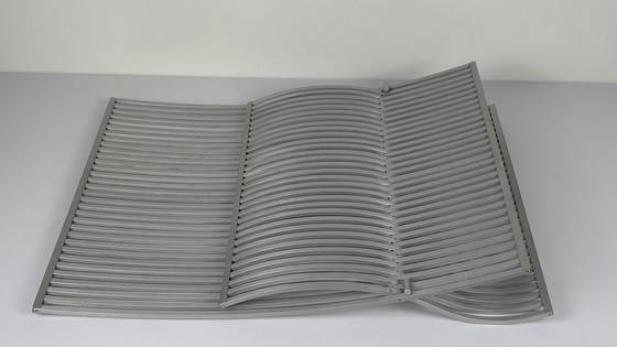 Image 1 of Soporte para libros y revistas UMBRA de lamas de aluminio cepillado. Plegable diseñador MICHELLE IVANKOVIC