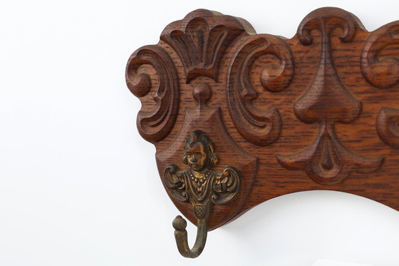 Image 1 of Antique Carved oak Wall mount coat rack with 3 brass angel hooks, France 1900s