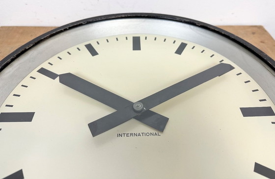 Image 1 of Zwarte industriële fabriekswandklok van International, jaren 50