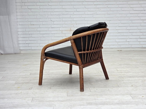 Image 1 of 1970s, Danish armchair, rattan, black artificial leather.