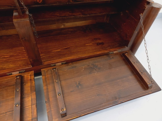 Image 1 of Een laag, brutalistisch dressoir van Georges Robert, gemaakt van donker grenenhout, uit de jaren 50/60.