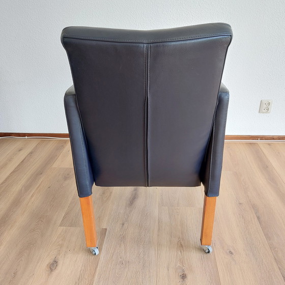 Image 1 of Set of 4 blue leather adjustable dining armchairs with wooden legs (on wheels)