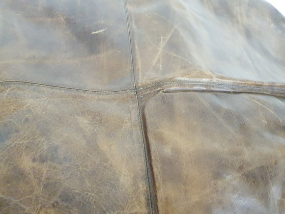 Image 1 of Dark brown leather ottoman. In good vintage condition