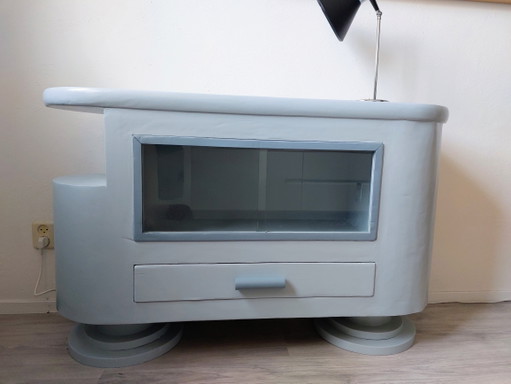 Sideboard with glass sliding doors and rounded shapes