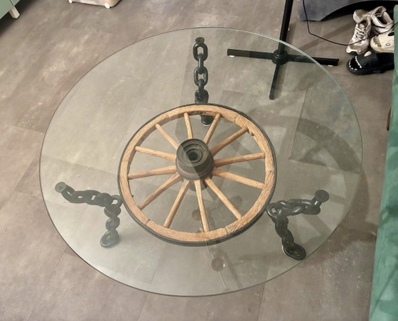 Image 1 of Tafel in de vorm van een wagenwiel met een massief glazen blad.