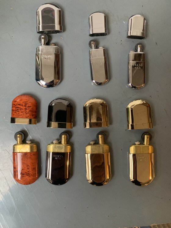 Image 1 of Verzameling Brass benzine aanstekers no 3 en no 5 in prima staat incl. leren hoesjes