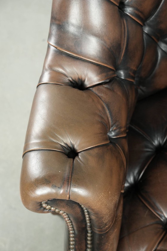 Image 1 of Grote bruine rundleren vintage chesterfield bureaustoel in hoogte verstelbaar en draaibaar op wieltjes met siernagels 