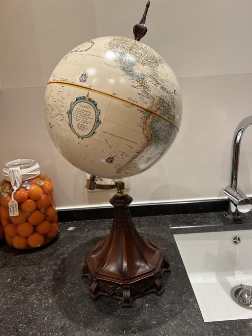 Wereldbol op mooi uitgekerfde houten voet