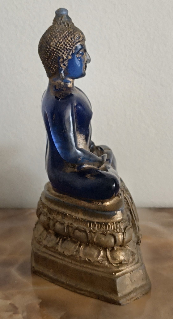 Image 1 of Old Buddha made of blue glass and stone material.