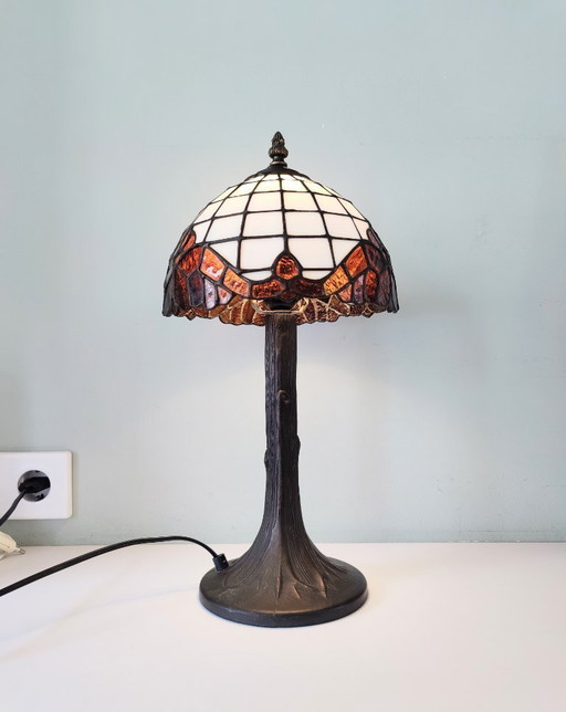Tiffany style table lamp with stained glass shade and bronze base