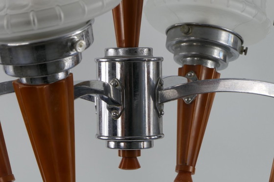 Image 1 of Chrome Art Deco chandelier with four amber Bakelite torches with decorated glass lampshades, ca. 1935