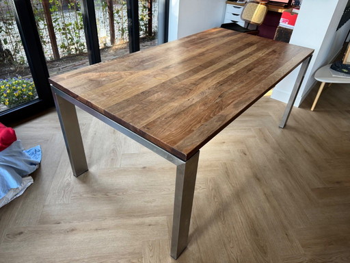 Walnut wood table with stainless steel legs