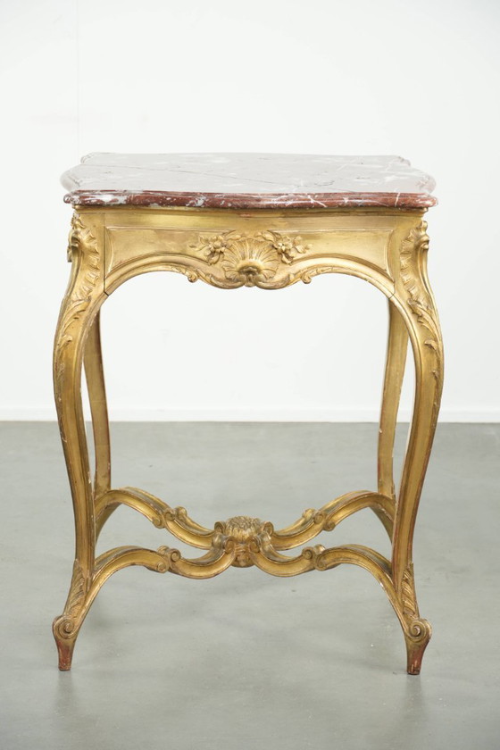 Image 1 of Antique French side table/center table from the 19th century with a gold-colored wooden frame and an original marble tabletop.