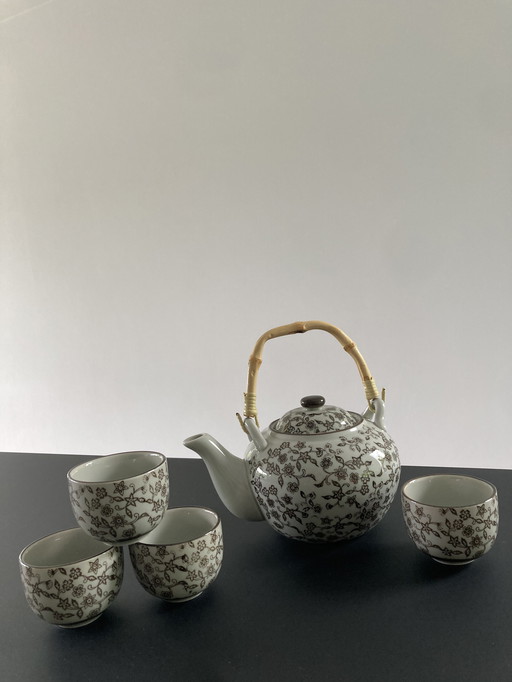 Gray ceramic tea set with brown floral pattern, four cups and a teapot