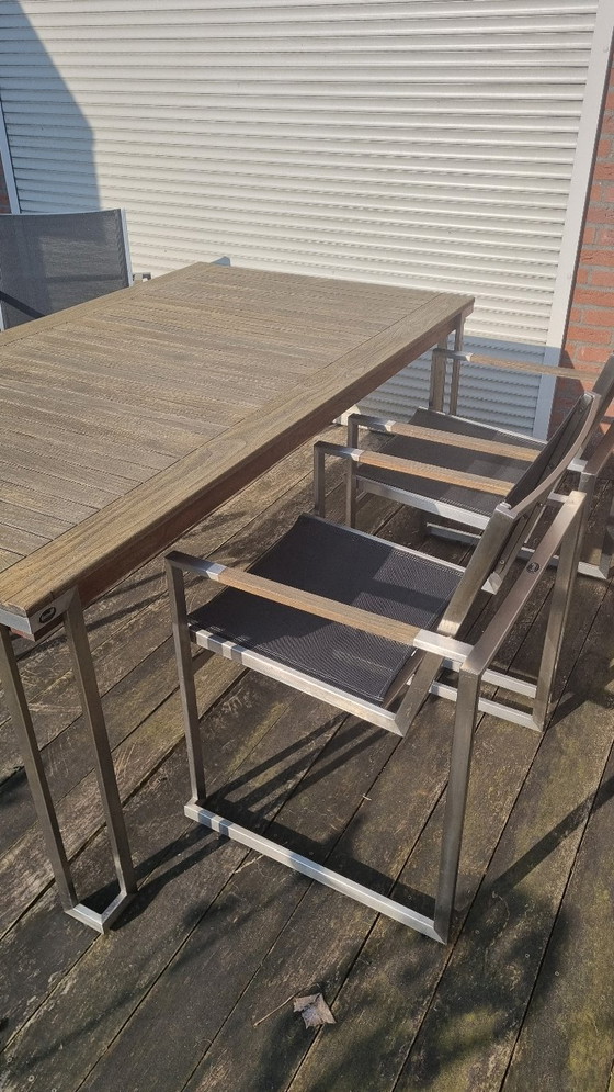 Image 1 of Set da giardino con tavolo in teak e 4 sedie in acciaio inox, realizzato in teak e textilene.